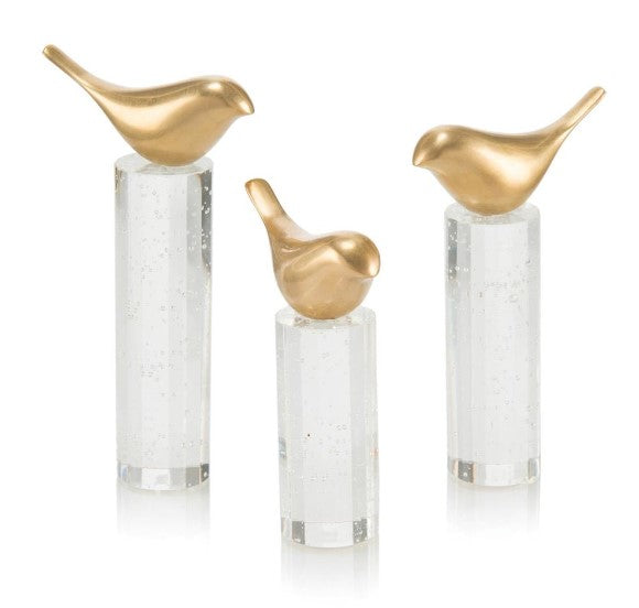    A Set Of Three Stylized Brass Birds Are Perched On Faceted Bubble Crystal Rods House of Reem by Reem Akkad Design