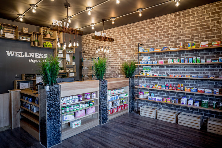 Reem Akkad Design Birmingham Michigan Detroit Wellness Store Interior Design with dark walls and brick walls and shelving for vitamins